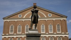 Red brick building with statue in front